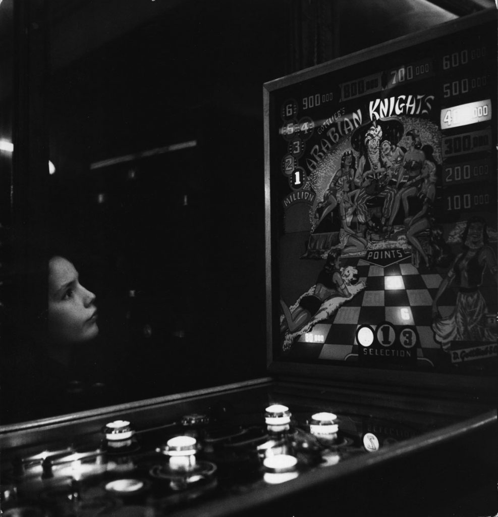 Janine Niepce: Rue Rousselet, Paris (Child Looking at Pinball Machine)